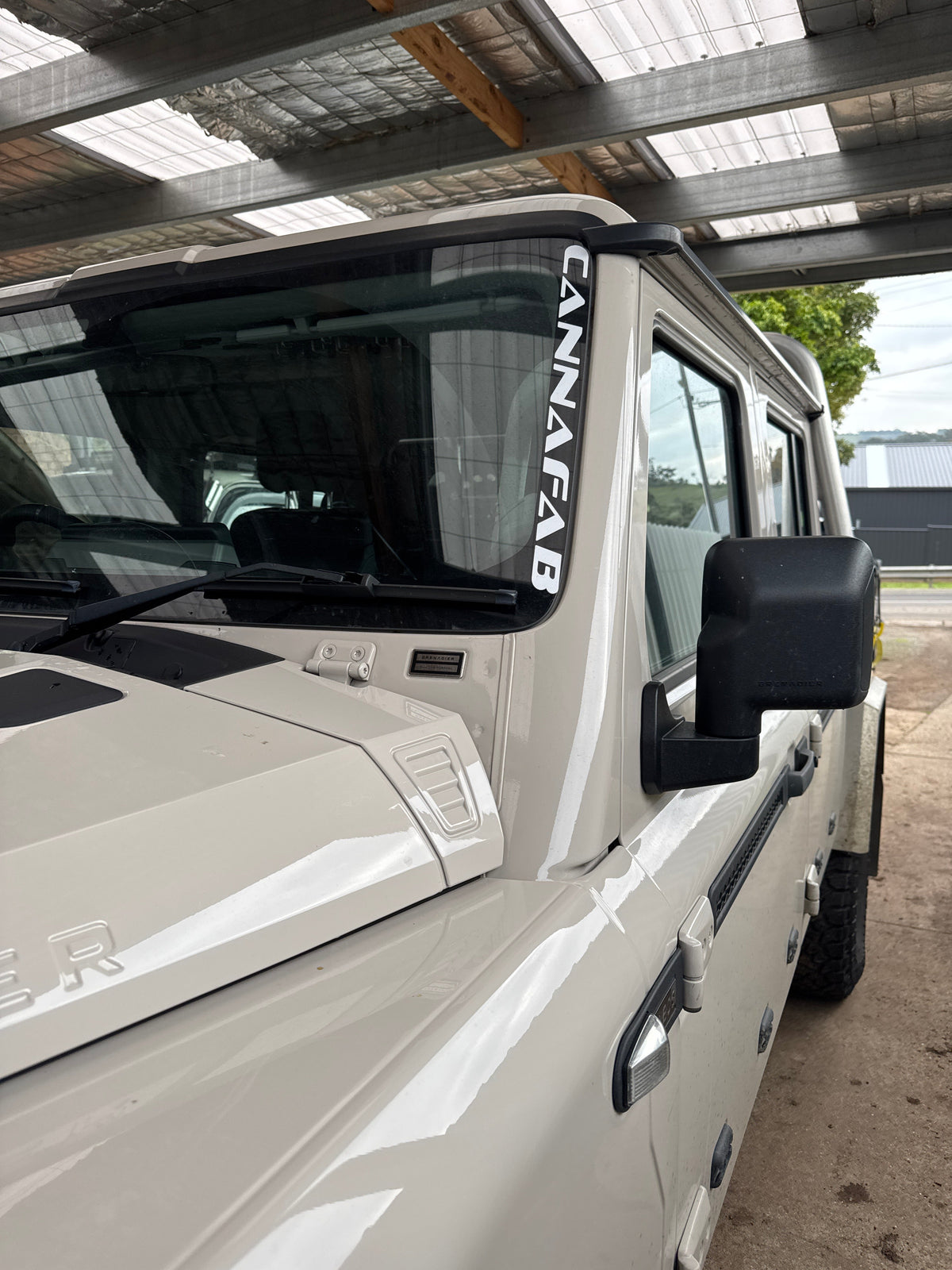 CannaFab snorkel sticker shown on the cab window of a white ute