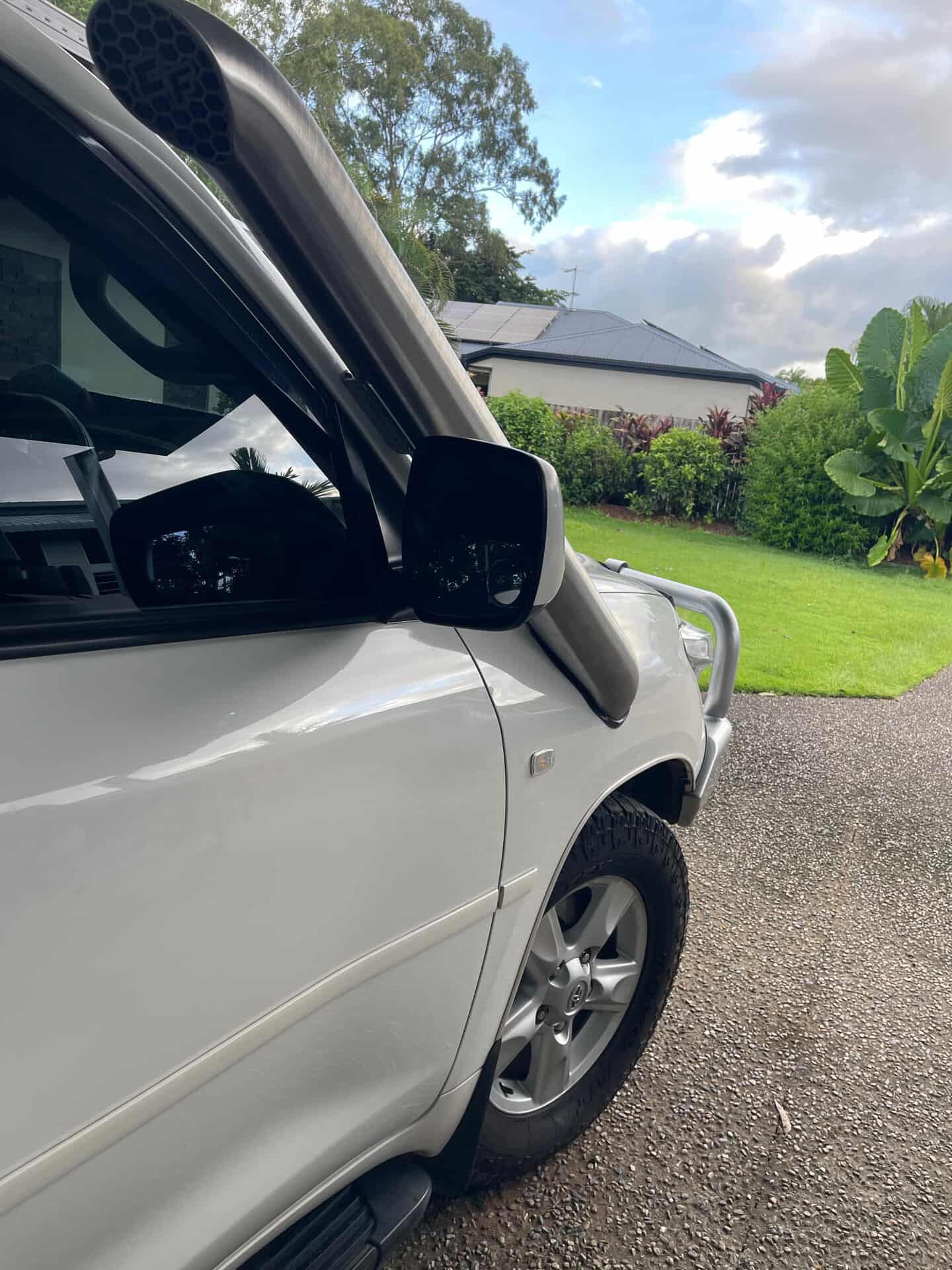 A-pillar view of Canna Fabrication stainless twin snorkels on a white Toyota LandCruiser 200 Series