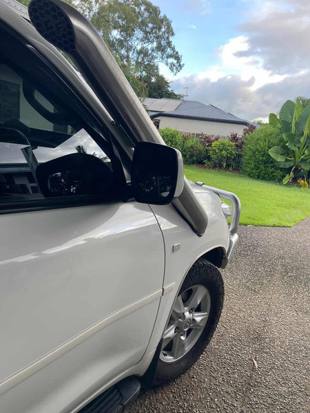 A-pillar view of Canna Fabrication stainless twin snorkels on a white Toyota LandCruiser 200 Series