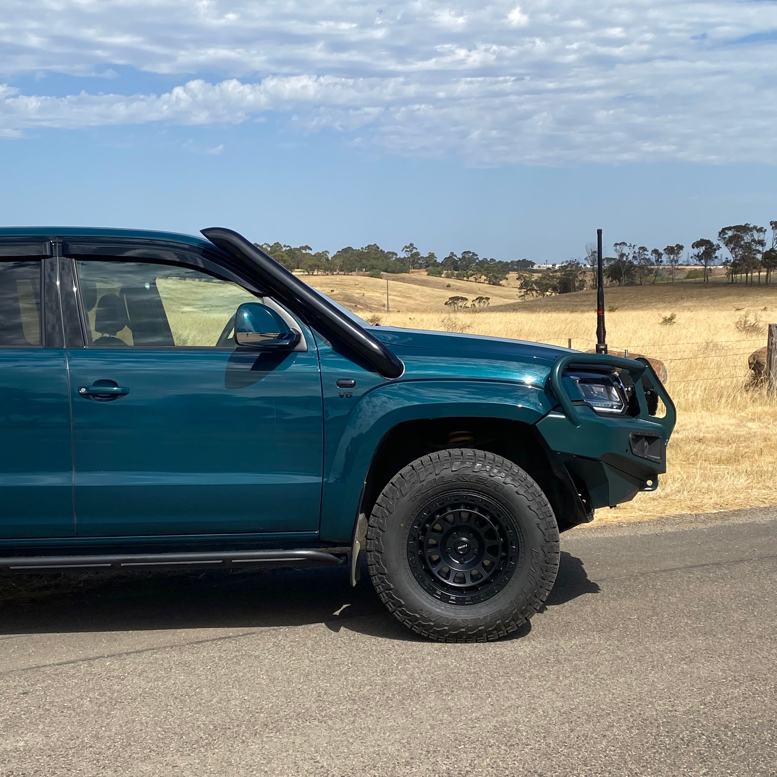 Green Volkswagen Amarok rear three-quarter view with Canna Fabrication stainless snorkel