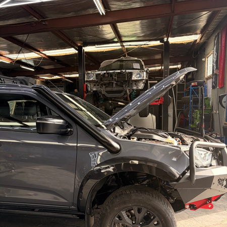 Isuzu D-MAX in the workshop during Canna Fabrication snorkel install, bonnet open