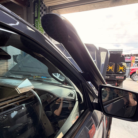 Close-up of the Canna Fabrication stainless snorkel beside the mirror on an Isuzu D-MAX