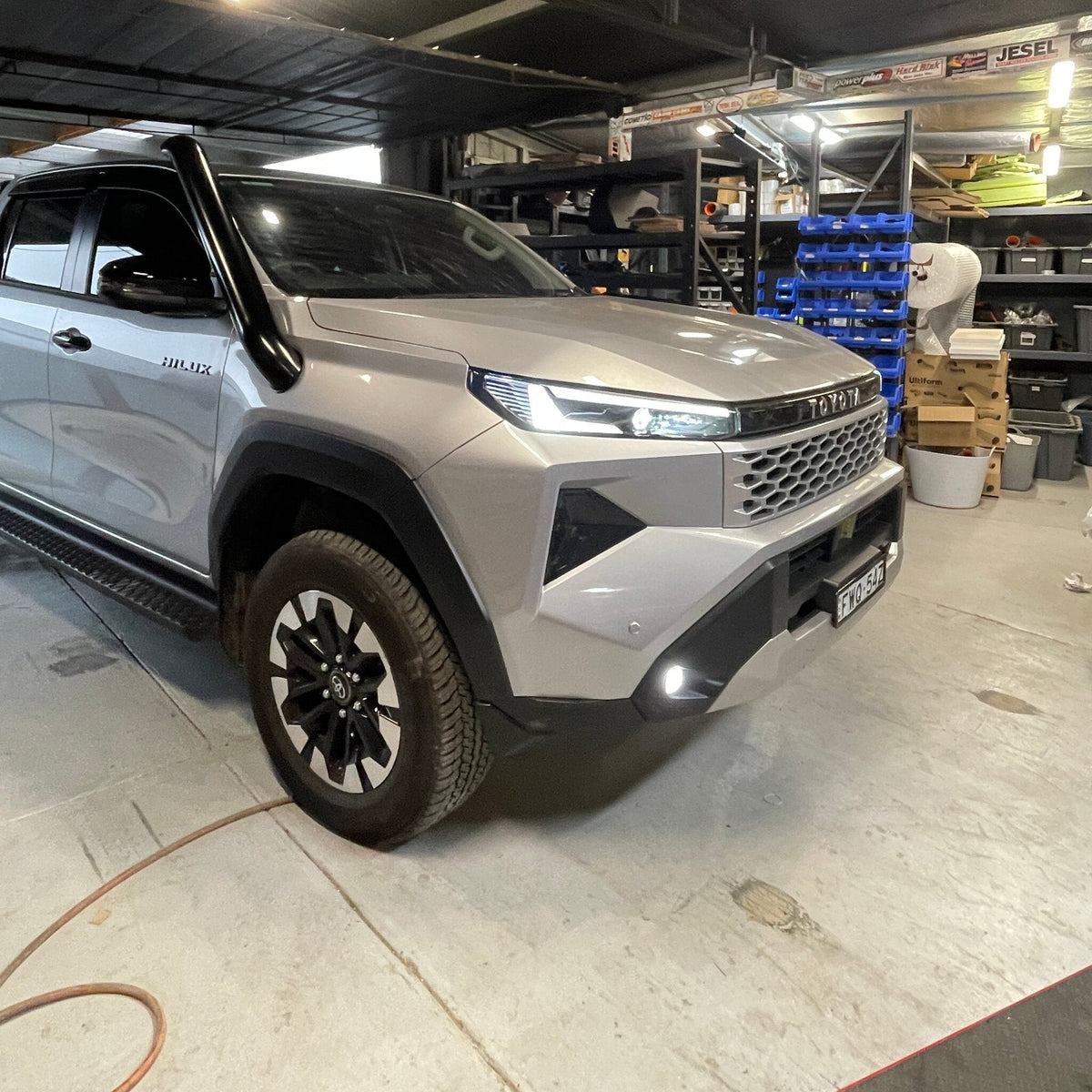 Silver Toyota Hilux N90 in the Canna Fabrication workshop with short-entry stainless snorkel