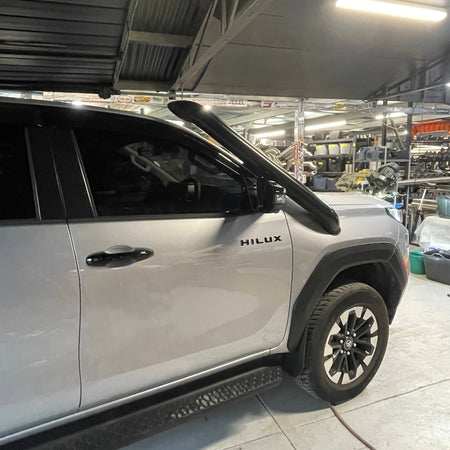 White Toyota Hilux N90 side view showing Canna Fabrication short-entry snorkel