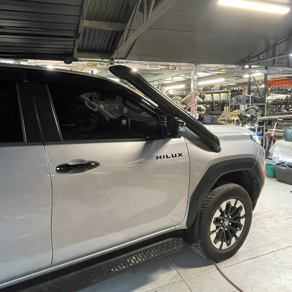 White Toyota Hilux N90 side view showing Canna Fabrication short-entry snorkel