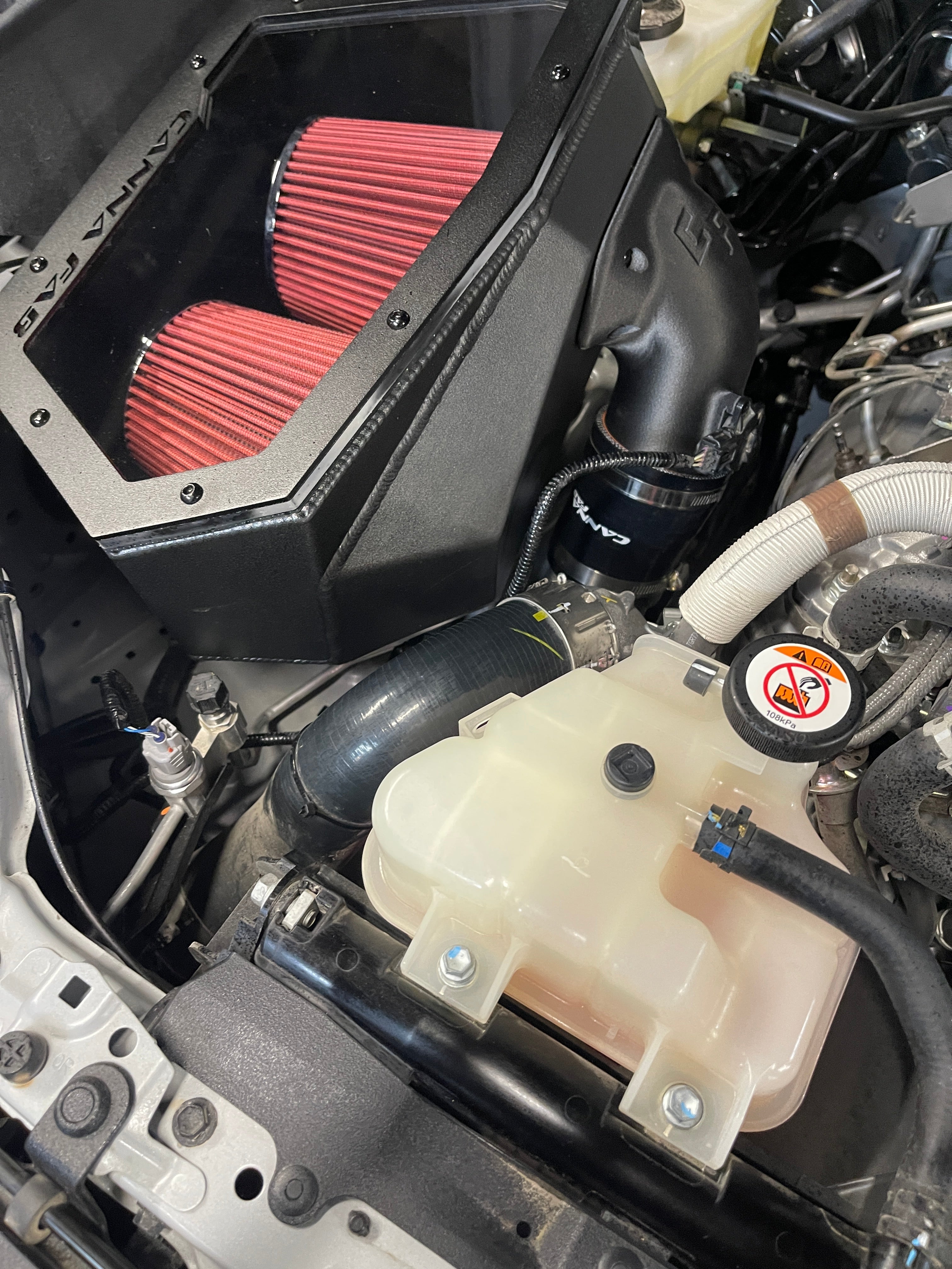 Top view of the Canna Fabrication twin pod filter airbox in a Toyota Hilux N90