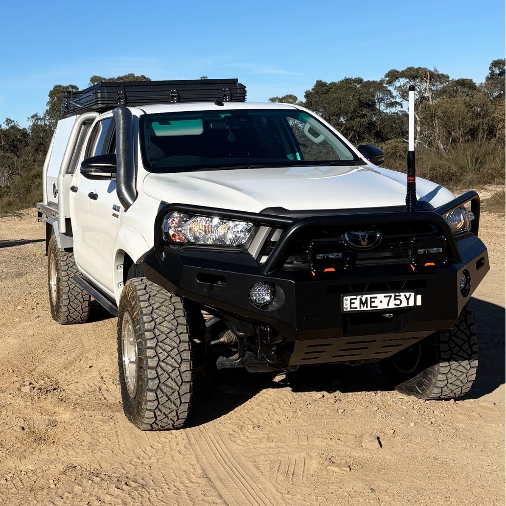 White Toyota Hilux N80 with black Canna Fabrication short-entry stainless snorkel — front three-quarter view