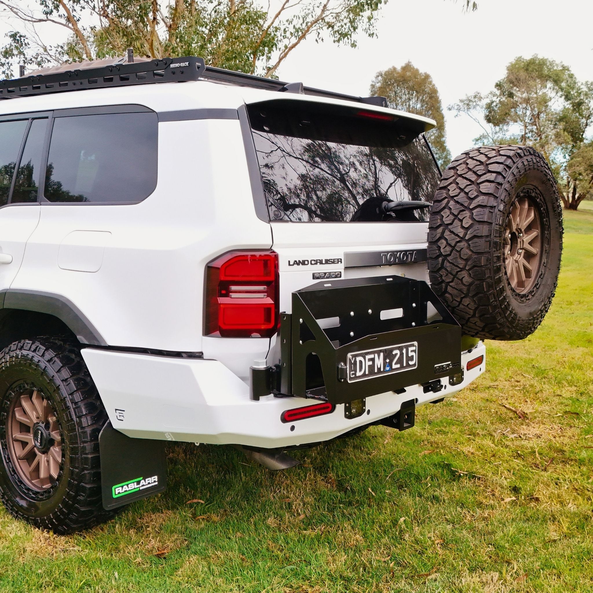 This is an image of the 250 Series Prado Toyota Landcruiser Rear Bar and Wheel Carrier setup by Raslarr Engineering Made in Australia White Black no jerry cans