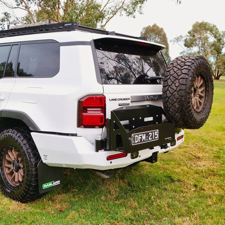 This is an image of the 250 Series Prado Toyota Landcruiser Rear Bar and Wheel Carrier setup by Raslarr Engineering Made in Australia White Black no jerry cans