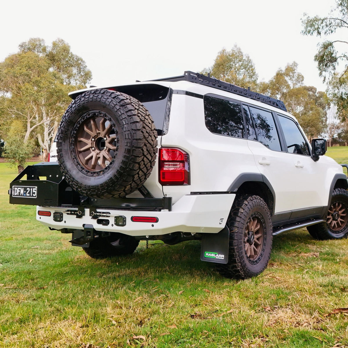 This is an image of the 250 Series Prado Toyota Landcruiser Rear Bar and Wheel Carrier setup by Raslarr Engineering Made in Australia