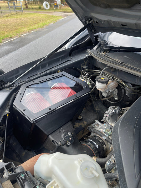 Canna Fabrication twin-pod filter aftermarket airbox with red pod filters installed in a 4WD engine bay (BT-50 / D-Max)